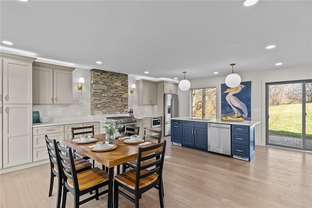 dining space with plenty of natural light, light hardwood / wood-style flooring, and sink