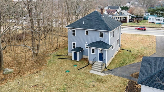 rear view of house featuring a yard