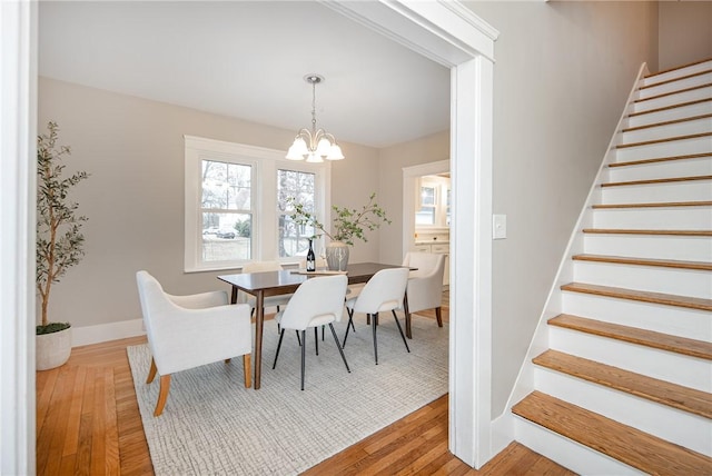 dining room featuring hardwood / wood-style floors and a chandelier