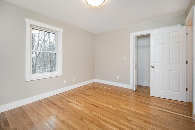 unfurnished bedroom featuring light wood-type flooring and a closet