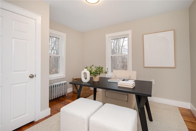 office space featuring radiator and dark hardwood / wood-style flooring