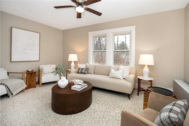 living room featuring radiator heating unit, ceiling fan, and wood-type flooring