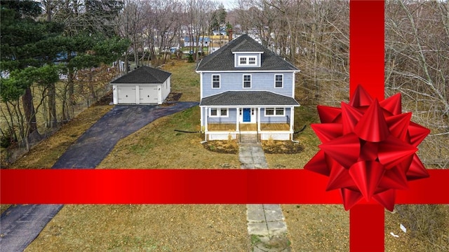 exterior space with an outbuilding, covered porch, a front yard, and a garage