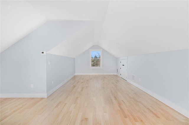 bonus room with light hardwood / wood-style floors and vaulted ceiling