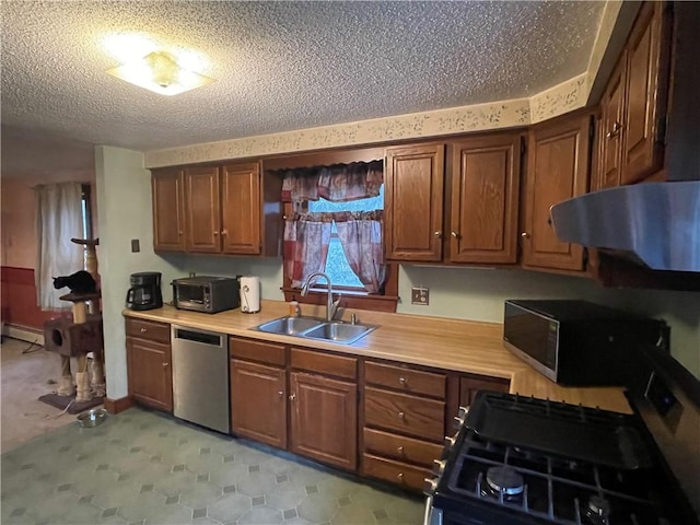 kitchen with exhaust hood, a baseboard heating unit, sink, a textured ceiling, and stainless steel appliances