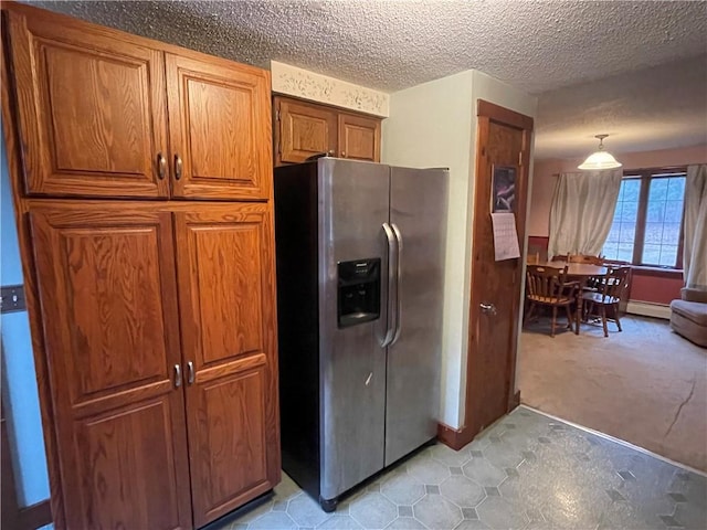 kitchen with pendant lighting, light carpet, a textured ceiling, baseboard heating, and stainless steel fridge with ice dispenser