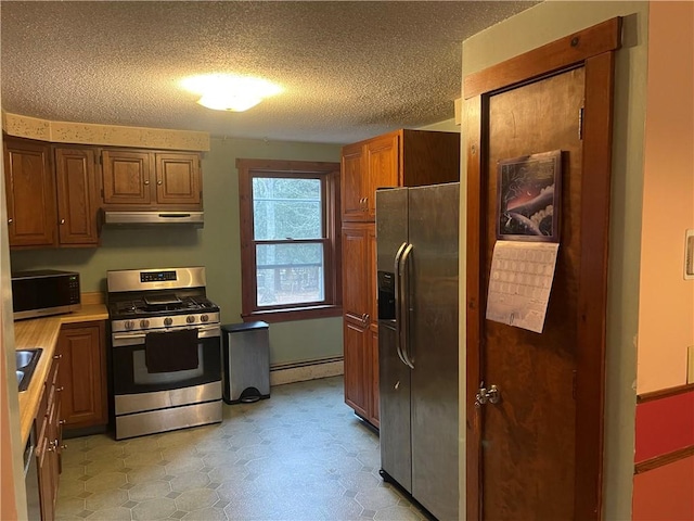 kitchen with baseboard heating, sink, stainless steel appliances, and a textured ceiling