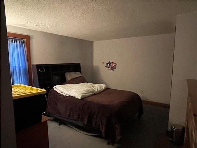 bedroom with carpet and a textured ceiling