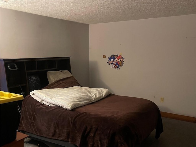 bedroom with carpet and a textured ceiling