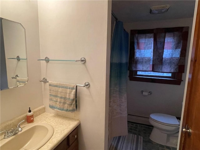 bathroom featuring vanity, toilet, walk in shower, and a baseboard heating unit