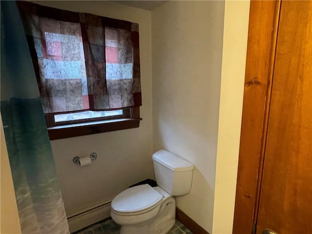 bathroom with tile patterned floors, a baseboard radiator, and toilet