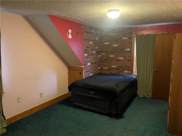 bedroom featuring dark carpet and a textured ceiling