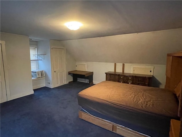 bedroom with dark colored carpet and lofted ceiling