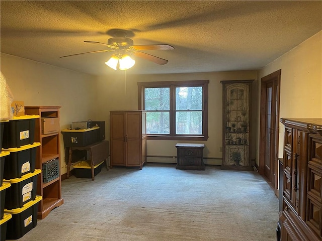 interior space with light carpet, a textured ceiling, baseboard heating, and ceiling fan