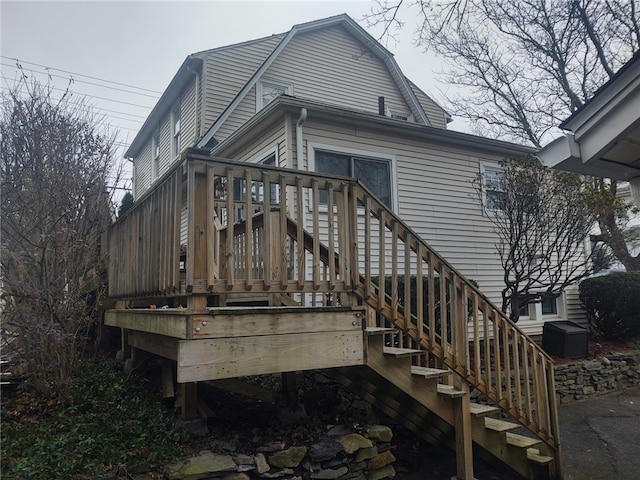 back of property featuring a wooden deck