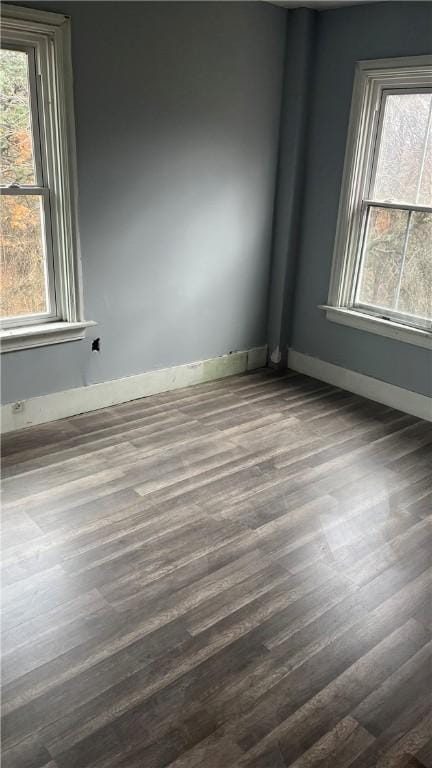 unfurnished room featuring dark hardwood / wood-style flooring