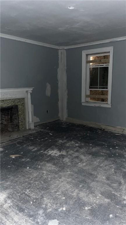 unfurnished living room featuring ornamental molding and a fireplace