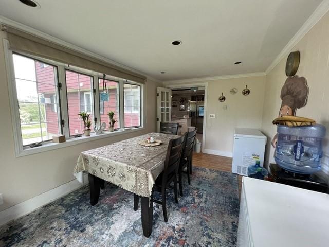 dining room with dark hardwood / wood-style floors and ornamental molding