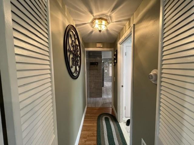 corridor with hardwood / wood-style floors