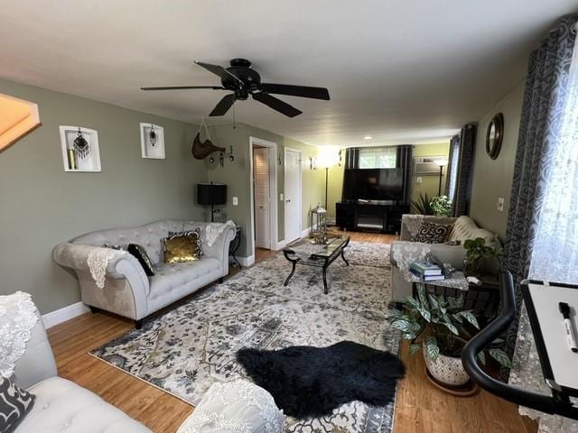 living room with hardwood / wood-style flooring and ceiling fan