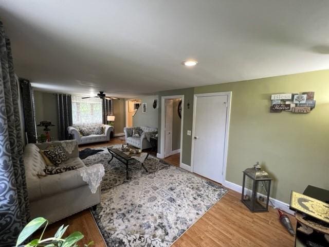 living room with ceiling fan and hardwood / wood-style flooring