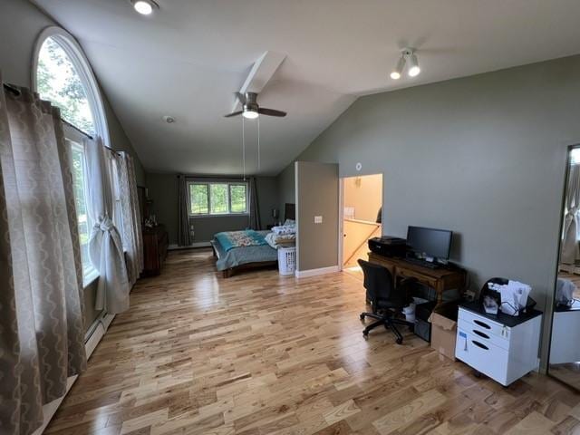 bedroom featuring ceiling fan, a baseboard radiator, wood-type flooring, and lofted ceiling