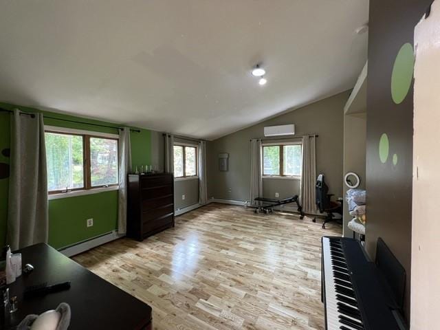 interior space with a baseboard heating unit, light wood-type flooring, an AC wall unit, and vaulted ceiling