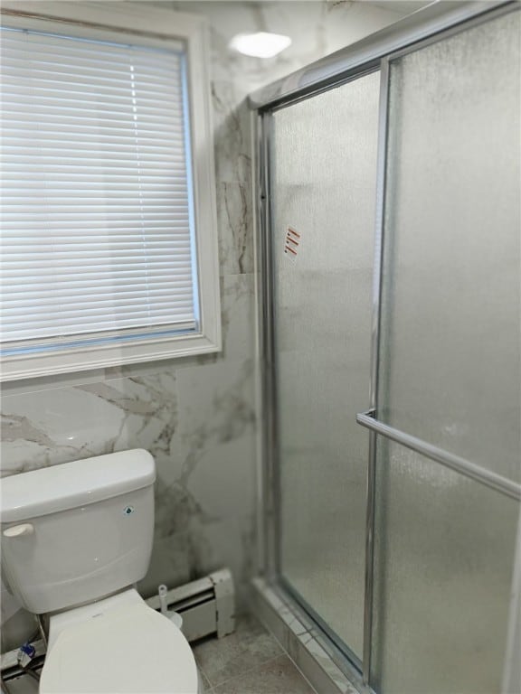 bathroom with a baseboard radiator, toilet, and walk in shower