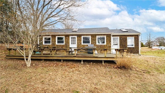 rear view of house with a wooden deck