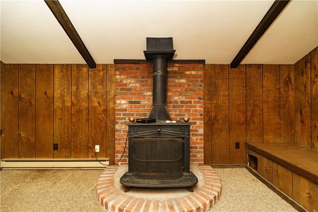 room details with beamed ceiling, a wood stove, baseboard heating, and wood walls