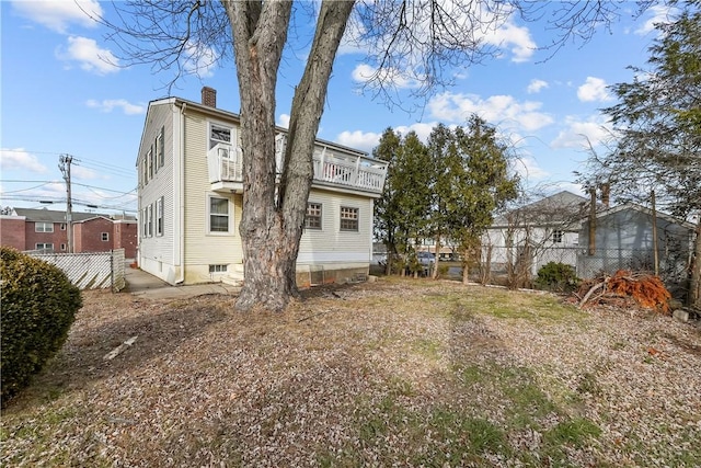 back of property with a balcony