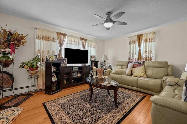 living room featuring hardwood / wood-style floors and ceiling fan