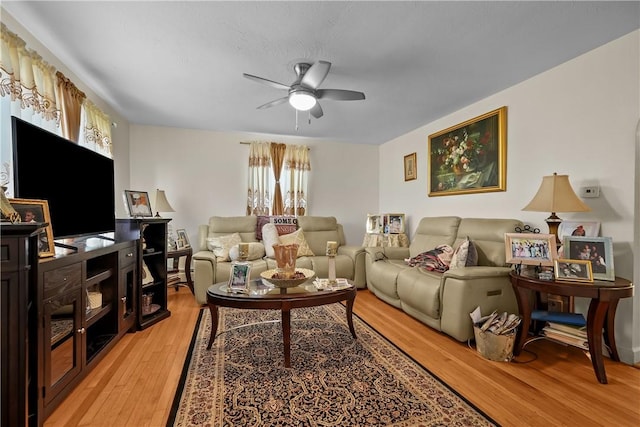 living room featuring hardwood / wood-style flooring and ceiling fan