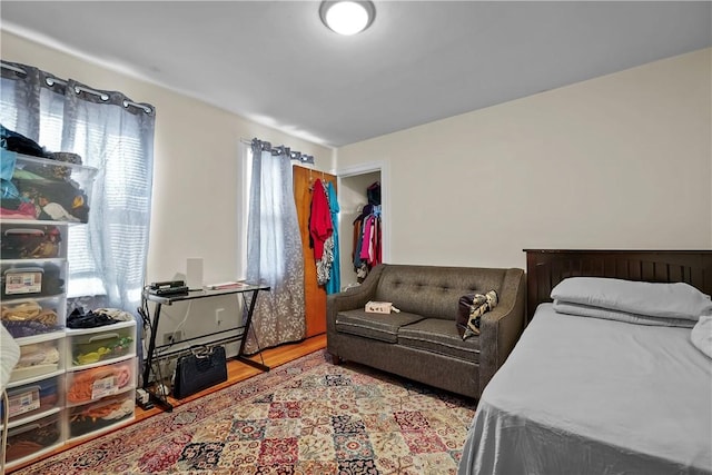 bedroom with multiple windows and light hardwood / wood-style flooring