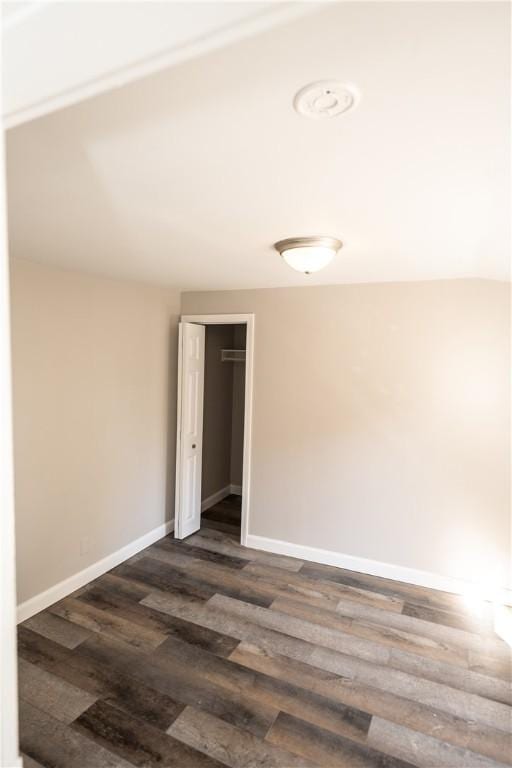 unfurnished room with dark hardwood / wood-style floors