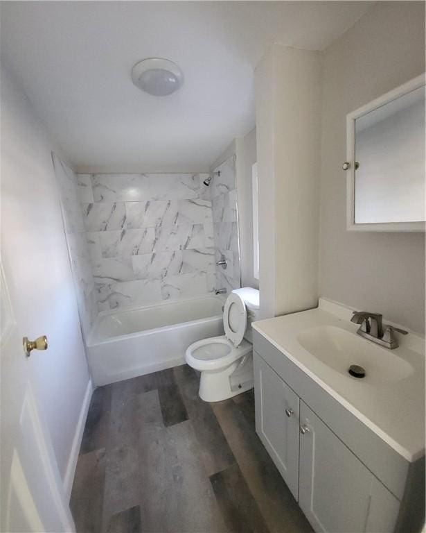 full bathroom featuring toilet, hardwood / wood-style floors, vanity, and tiled shower / bath