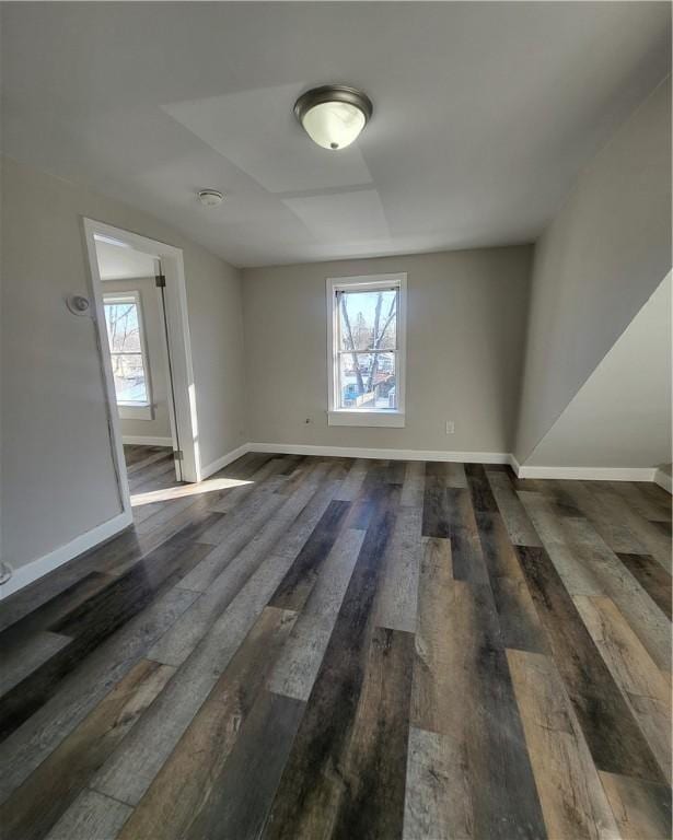 unfurnished room with dark hardwood / wood-style flooring and a wealth of natural light