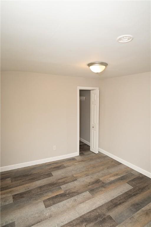 empty room featuring dark wood-type flooring