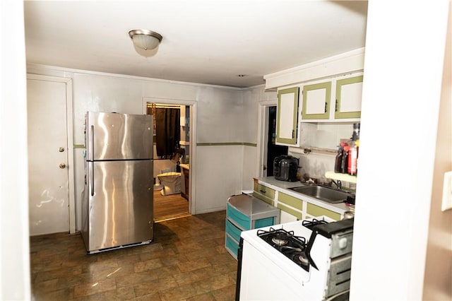 kitchen featuring stainless steel refrigerator, gas range gas stove, and sink