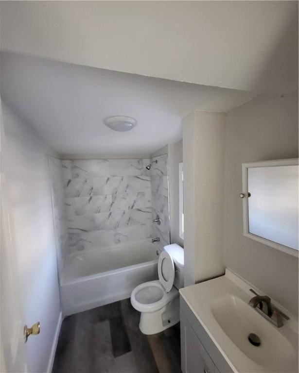 full bathroom featuring toilet, vanity, tiled shower / bath combo, and hardwood / wood-style flooring