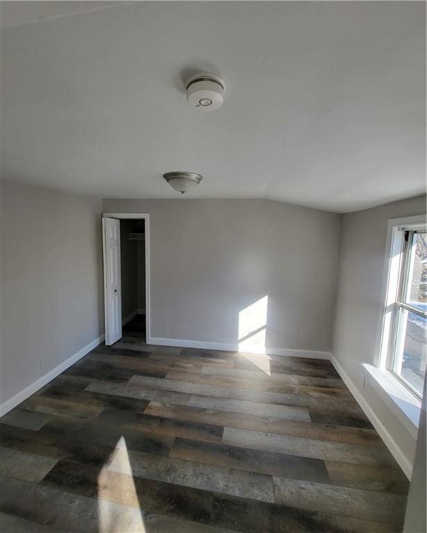 empty room with dark hardwood / wood-style flooring