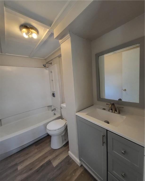 full bathroom with hardwood / wood-style floors, vanity, shower / bath combination, and toilet