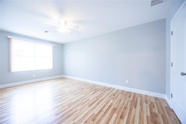 empty room with ceiling fan and light hardwood / wood-style floors