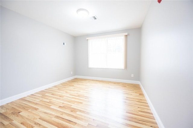 spare room with light hardwood / wood-style floors