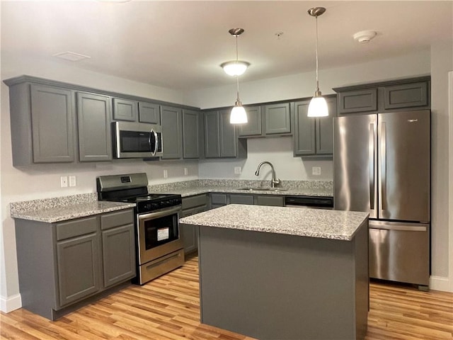 kitchen featuring a center island, stainless steel appliances, and gray cabinetry