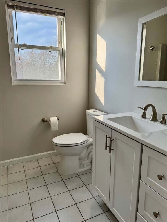 bathroom featuring tile patterned flooring, vanity, and toilet