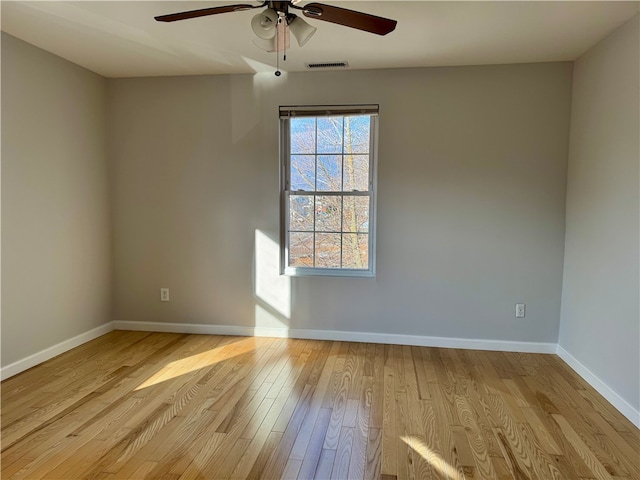 unfurnished room featuring light hardwood / wood-style flooring and ceiling fan