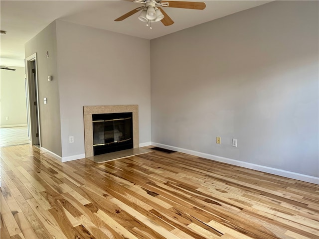 unfurnished living room featuring ceiling fan and light hardwood / wood-style floors