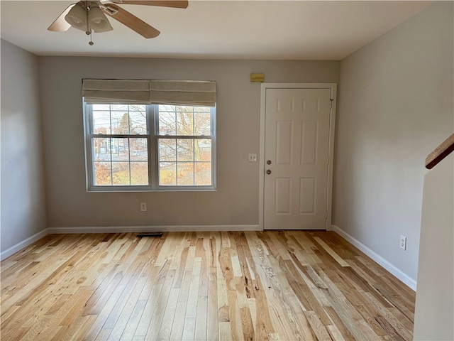 foyer entrance with ceiling fan and light hardwood / wood-style flooring