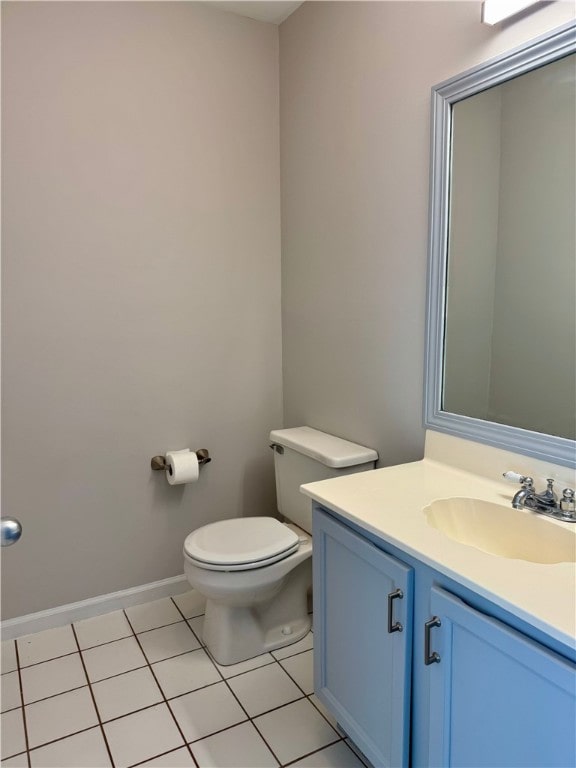 bathroom featuring tile patterned flooring, vanity, and toilet